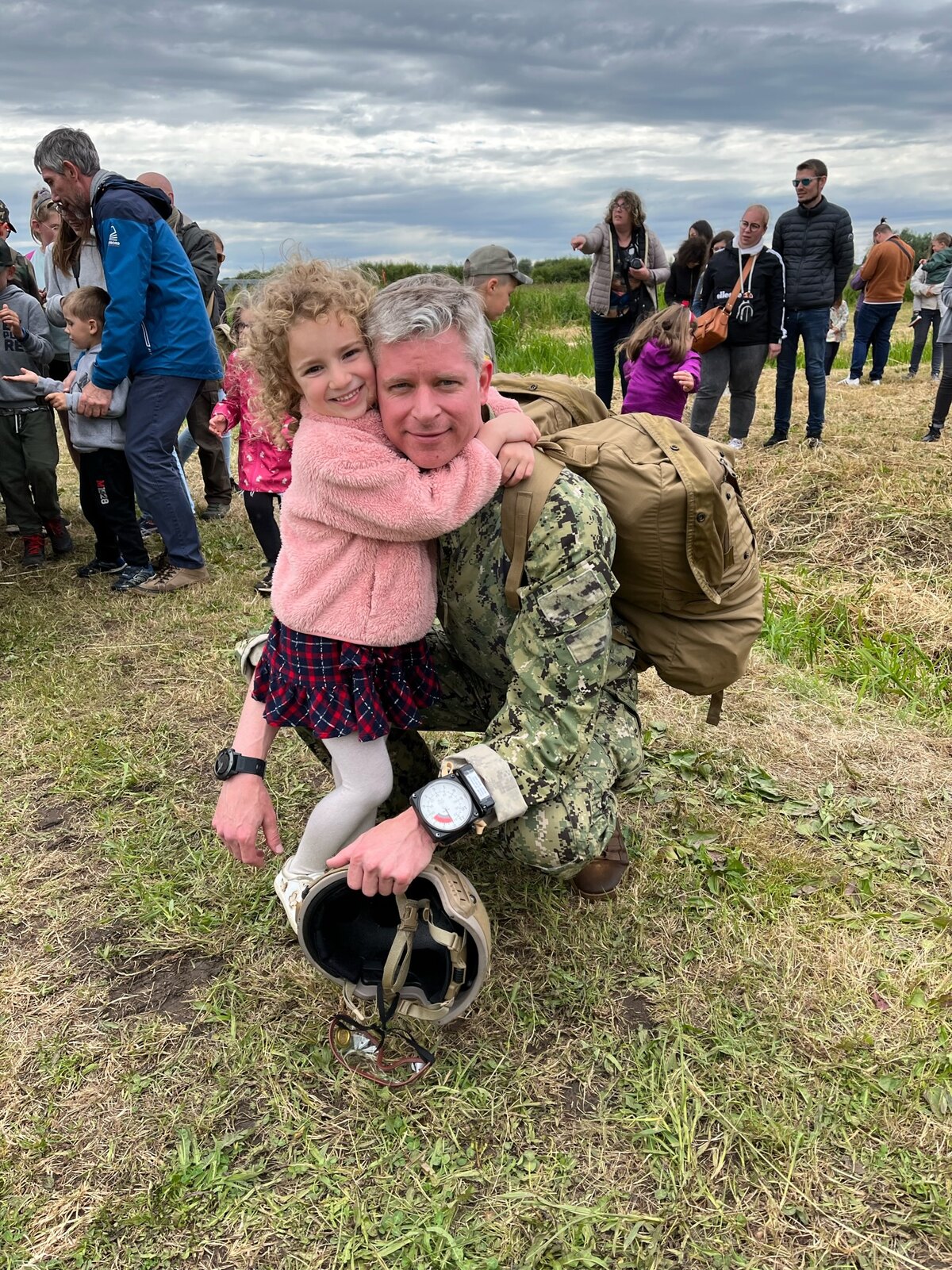 Captain Cunningham in operational uniform with his daughter after a jump